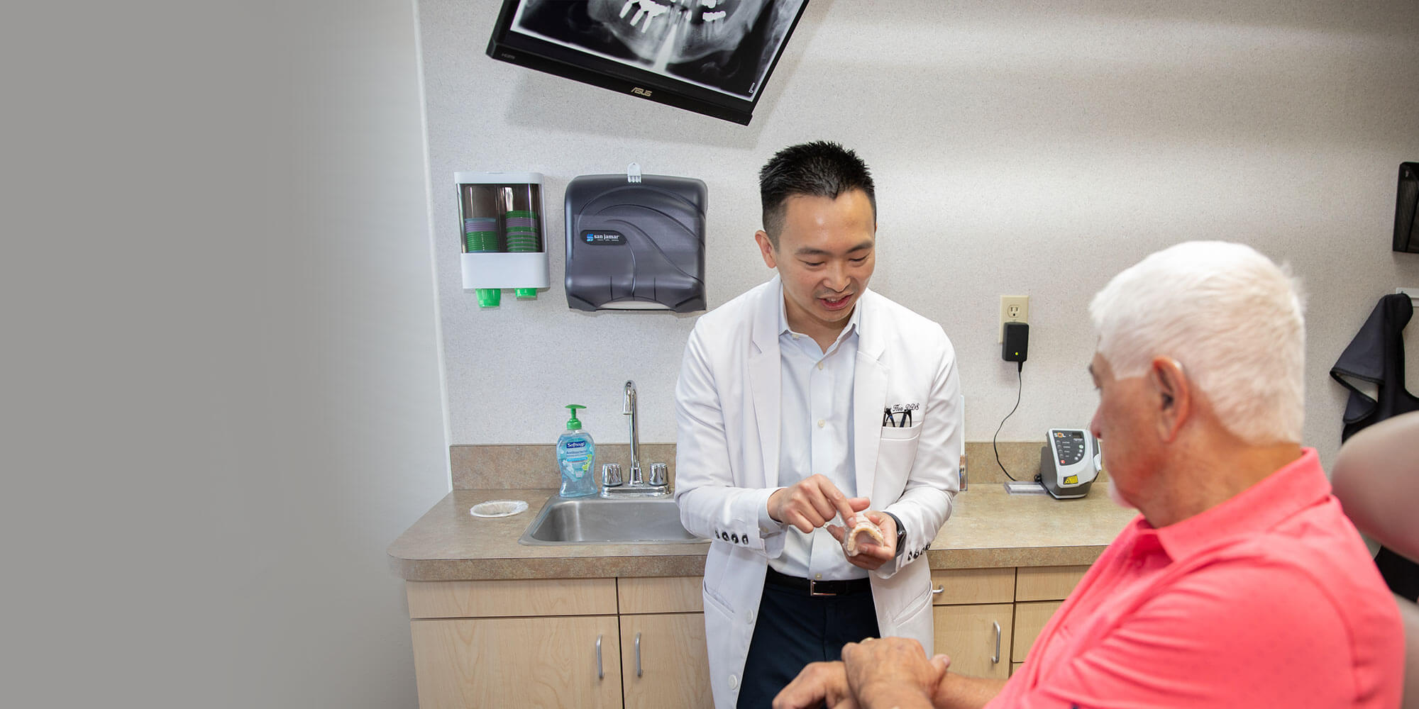 dr. hua showing patient zirconia dental implants